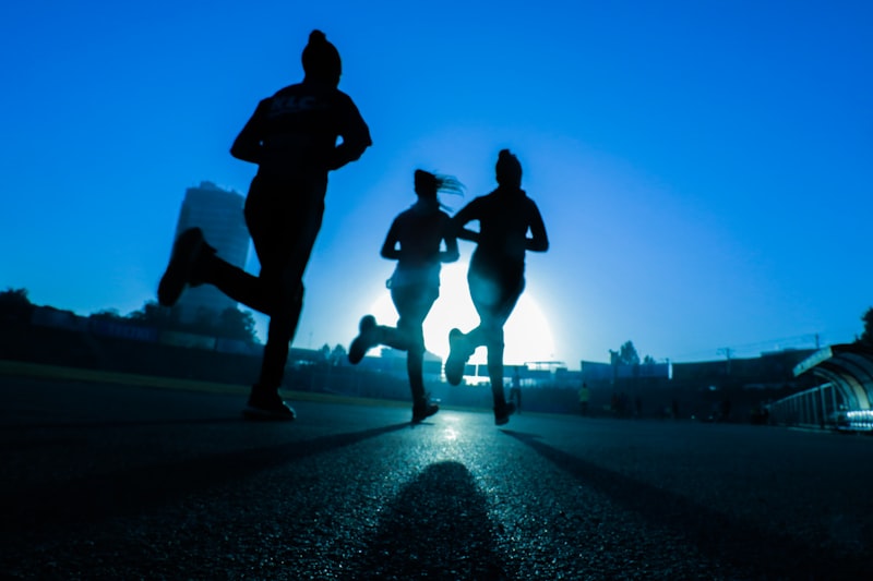 Person running on mountain trail at sunrise